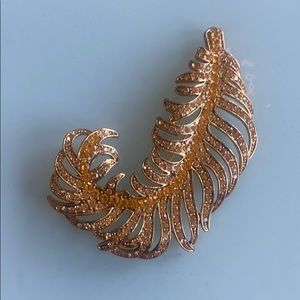 Gold brooch feather with golden rhinestone